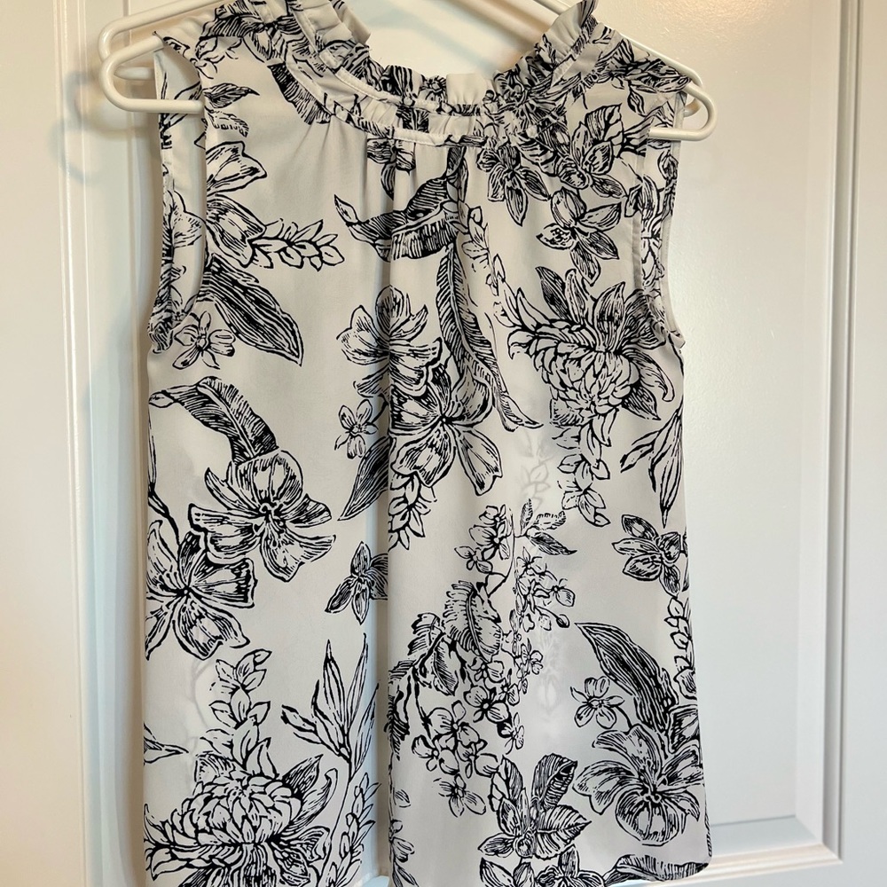 Ruffled white and navy blue blouse. Perfect for going into the office.